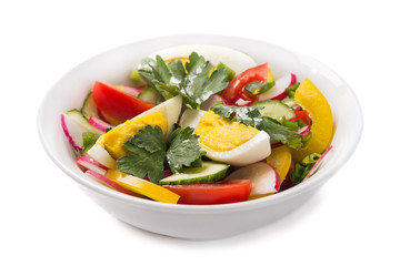 Fresh vegetable salad with eggs on a white background