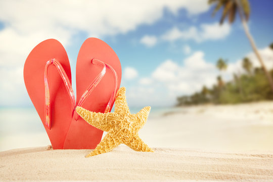 Summer Beach With Red Sandals And Shells