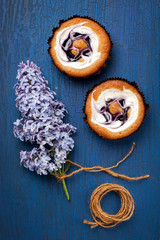 Cakes with berries and cream on blue background