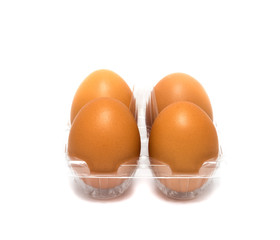 Fresh brown eggs in plastic carton on  white background.