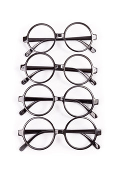 Stack of black glasses isolated on white