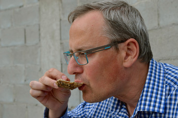 man eating oyster