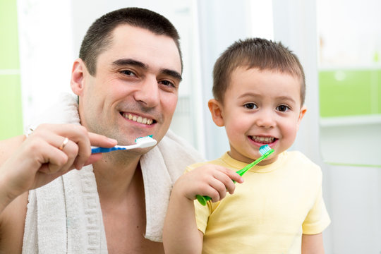 Father And Child Boy Brushing Teeth Before Going To Bed