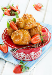 Profiteroles with nuts and strawberries