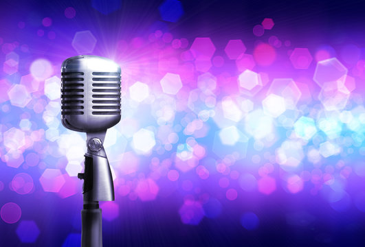 Close up of silver microphone, on glowing background