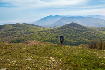 woman hiking on forest and mountain background