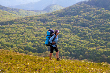 woman hiking on forest and mountain background