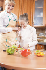 Female Blond Teaching Her Daughter to Cook