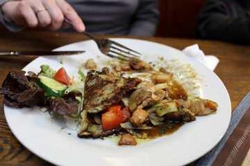 Person eating potato pancake