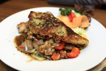 Potato pancake with smoked meat and cabbage