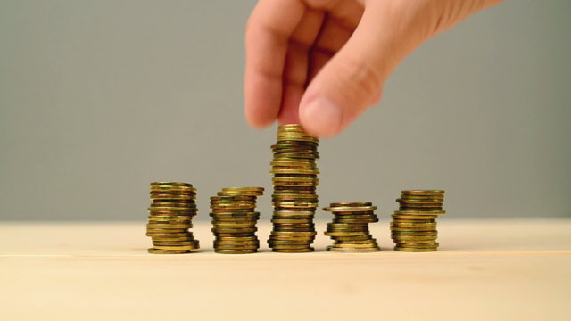 Hand stacking coins. Saving money, managing home budget. 