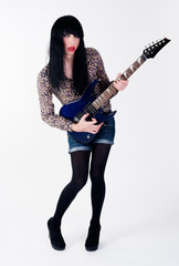 transvestite in heels with electric guitar