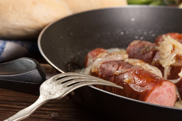 Fried sausage with onions.