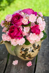 beautiful garden roses in a tea pot