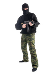 masked man stands with rifle