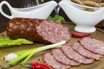 sausages on a wooden plate with vegetables in a restaurant