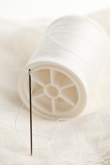 Fototapeta na wymiar Sewing needle and thread macro