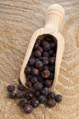 Juniper berries in wooden scoop