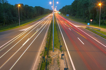 Highway with light trails at dusk