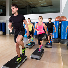 Cardio step dance group at fitness gym training