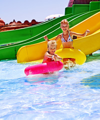 Child on water slide at aquapark.