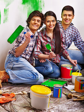 Happy family laying parquet at home.