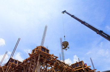 Fototapeta na wymiar Crane working in construction on blue sky