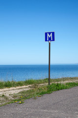 European road sign passing place by a road along coastline
