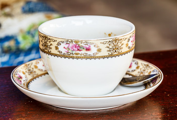large cup of coffee with a pattern on foams and croissants on a