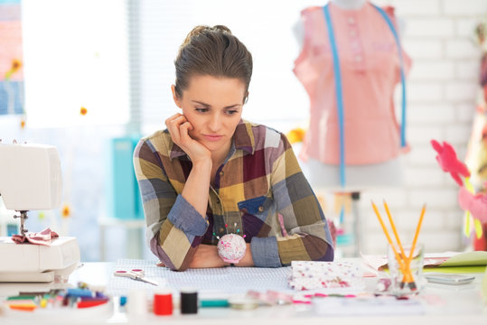 Portrait of concerned seamstress in studio