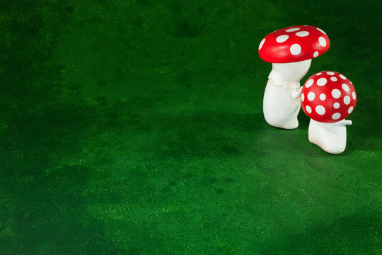 cute puppets handmade, two mushrooms, green background