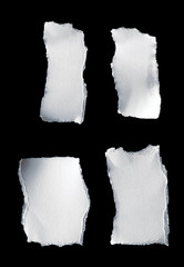 Scrap of white paper on black background