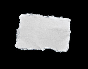 Scrap of white paper on black background