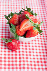 Small bowl filled with succulent juicy fresh ripe red strawberri