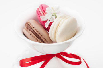 Three different sweet and colourful french macaroons in vase  an