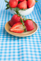 Small plate and bowl filled with succulent juicy fresh ripe red