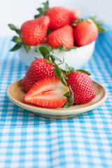 Small plate and bowl filled with succulent juicy fresh ripe red