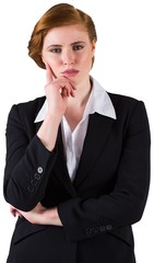 Thinking redhead businesswoman in suit