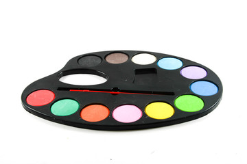 black art palette with paint and brushes isolated on whi