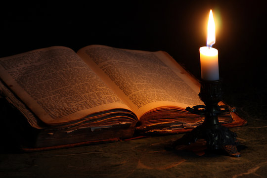 old open book with candle