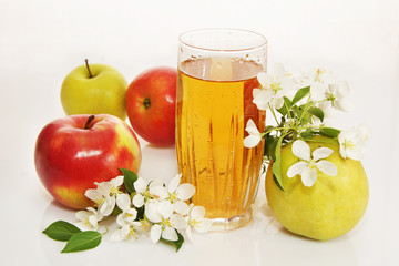 Still life with a glass of fresh apple juice and ripe apples