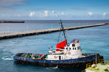 Blue and Red Tugboat in Blue Harbor