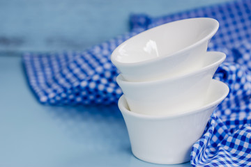 Different tableware on  table. white kitchen bowls