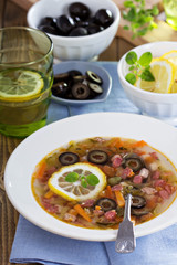 Soup with meat, sausage and olives