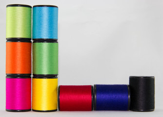 set of color threads on a white background