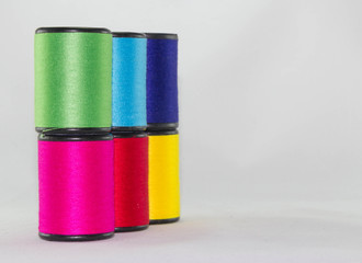 set of color threads on a white background