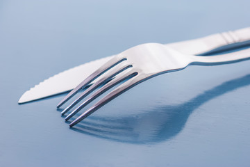 fork and knife on a napkin on the table