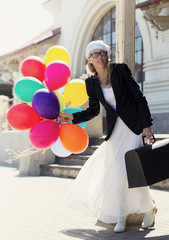 Retro fashioned woman with colorful balloons