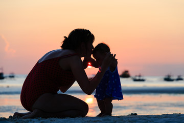 mother and daughter on sunset beach © nadezhda1906