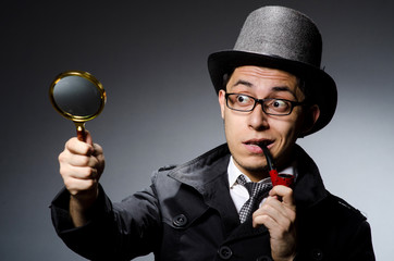 Funny detective with pipe and hat